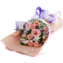 Bouquet composed of 11 pink roses accented by white and purple lisianthus, baby's breath and fresh greens.